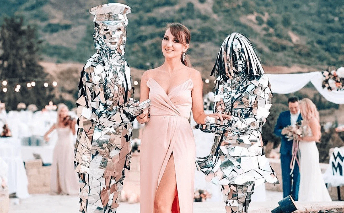 Woman posing with mirror performers at an outdoor event in Paphos