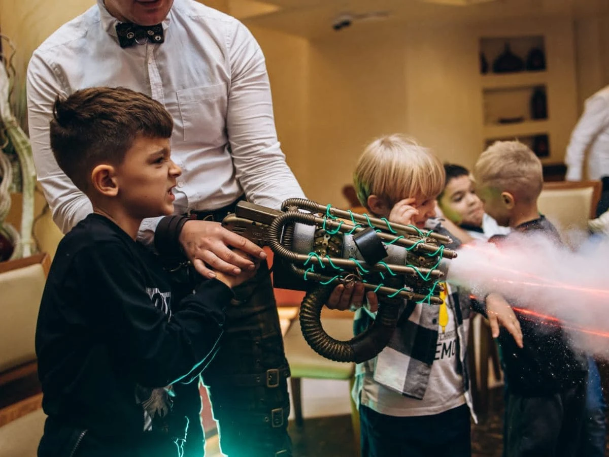 A boy is playing with a toy gun