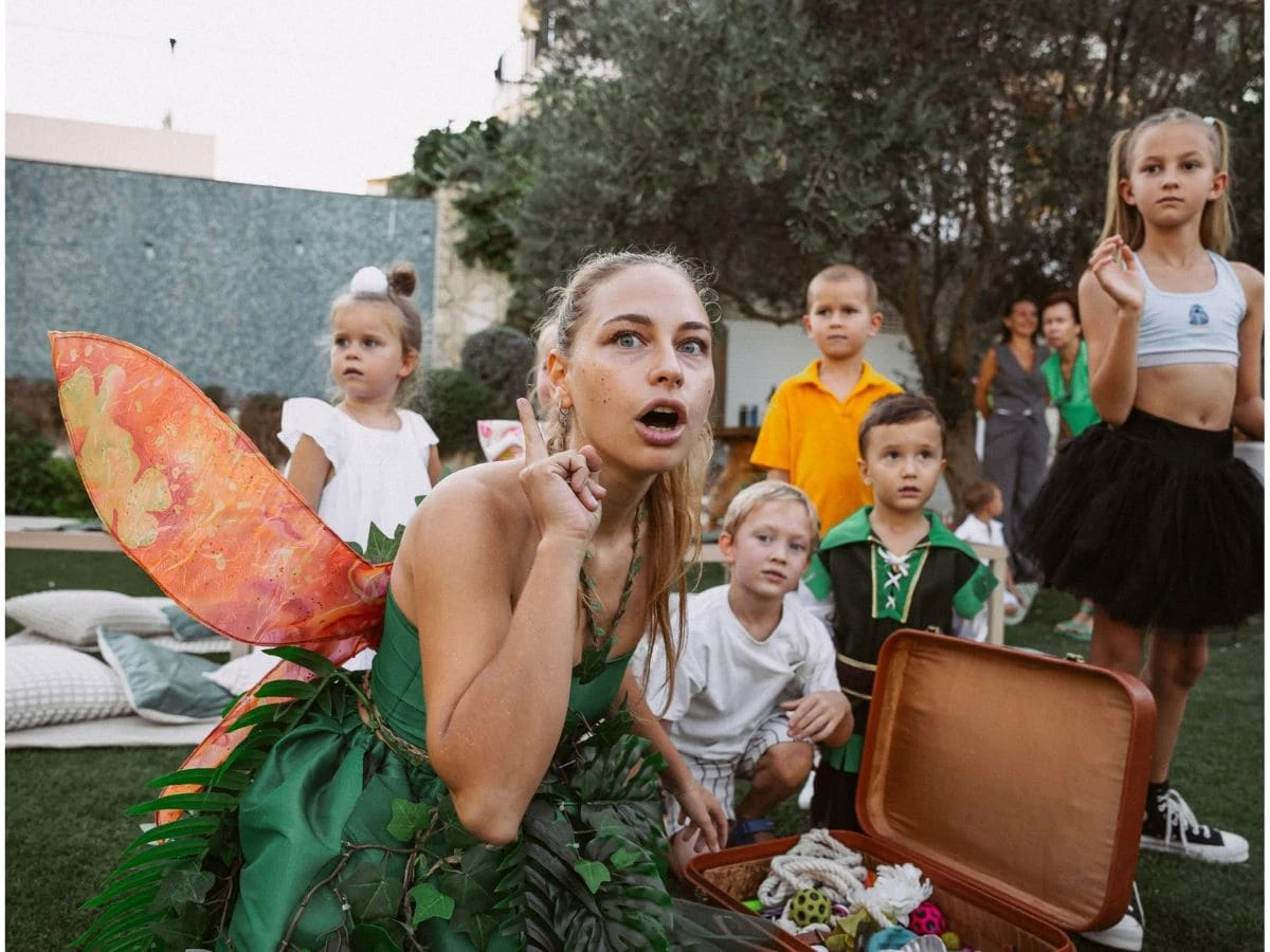 A girl in a fairy costume with children