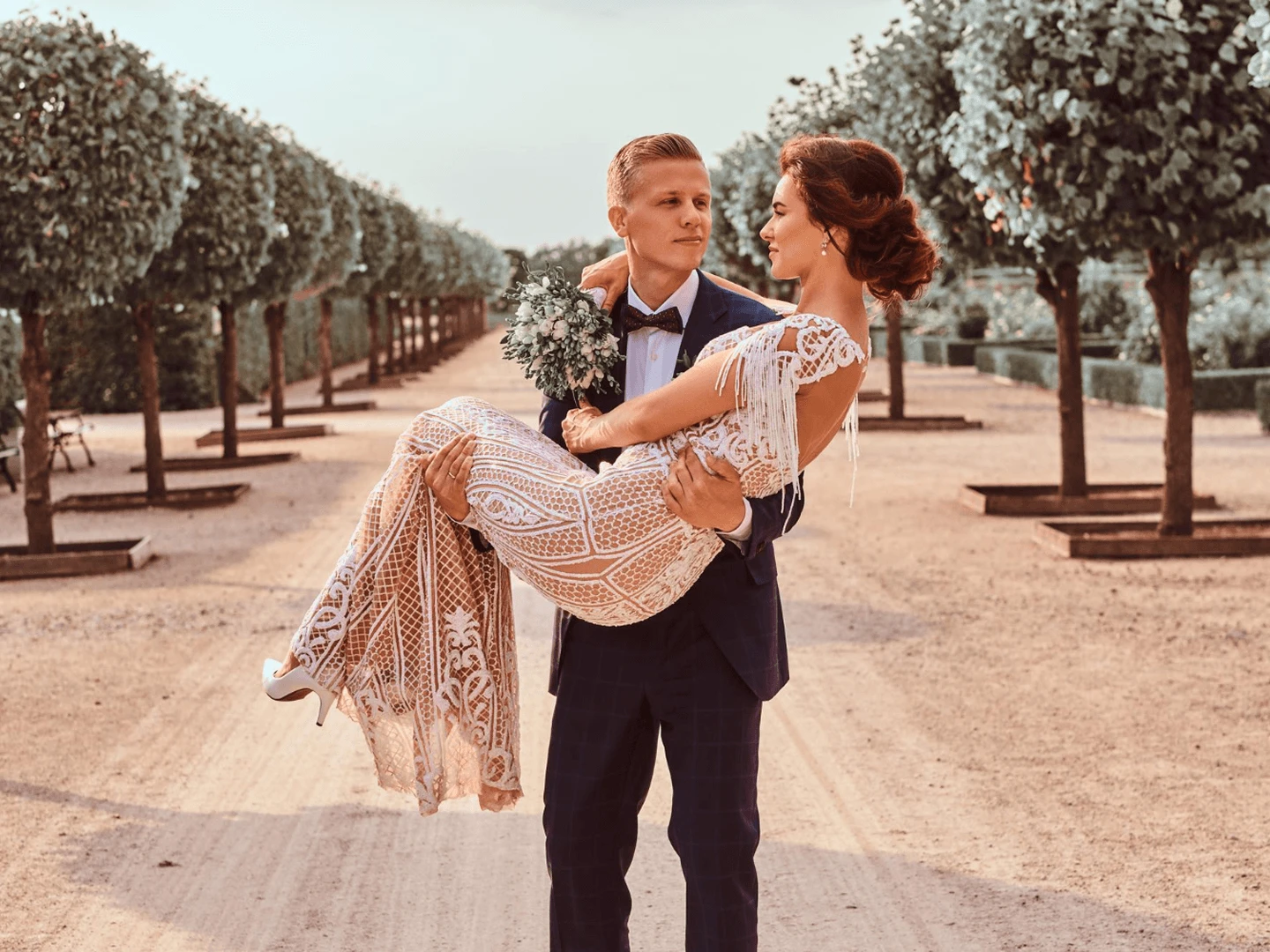 Sunset wedding reception on a Limassol seafront terrace in late June, with string lights and floor-length linen tablecloths.