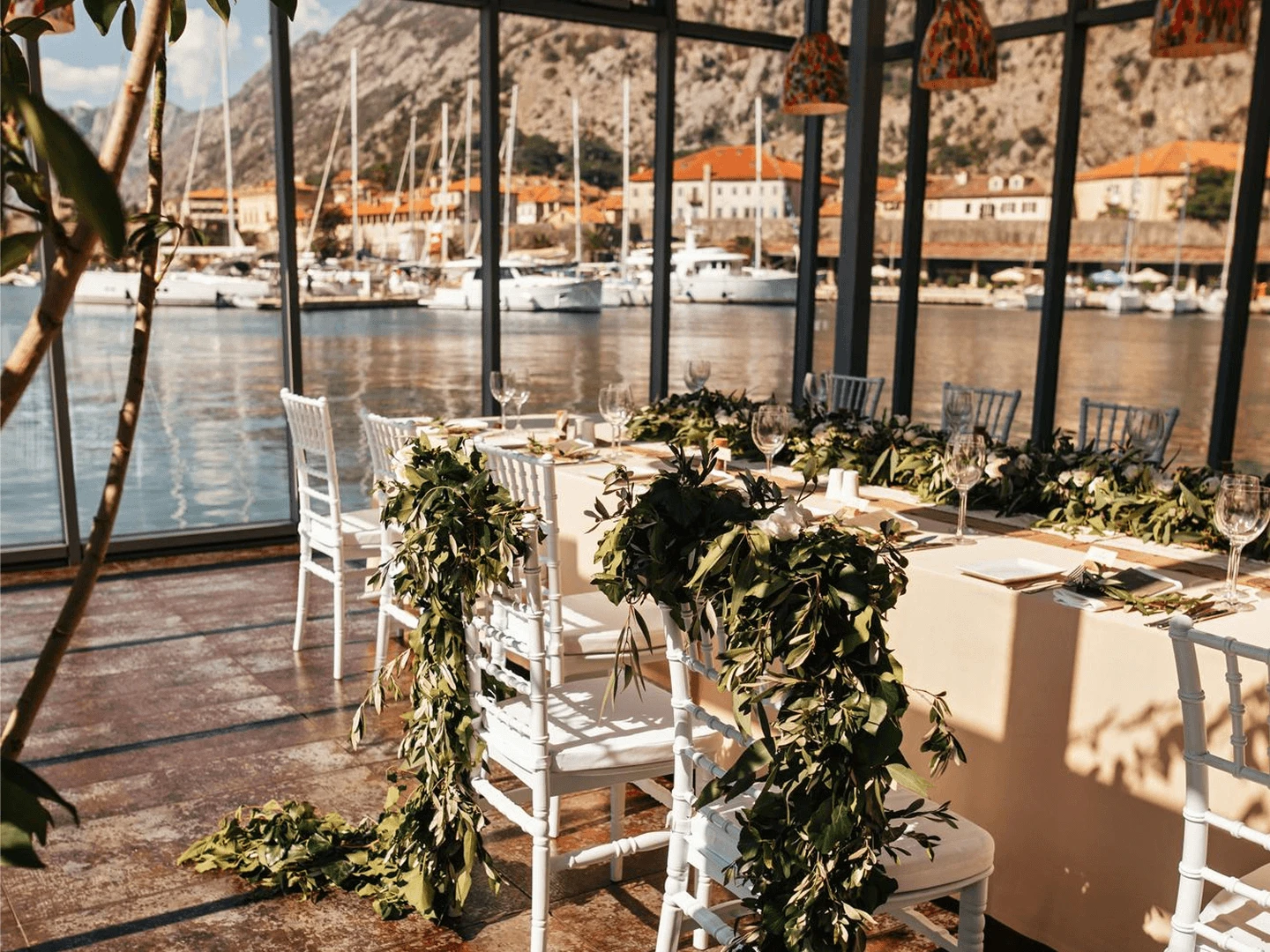 Intimate covered villa wedding ceremony in November in the Paphos hills, with candlelight and twelve guests seated under draping.