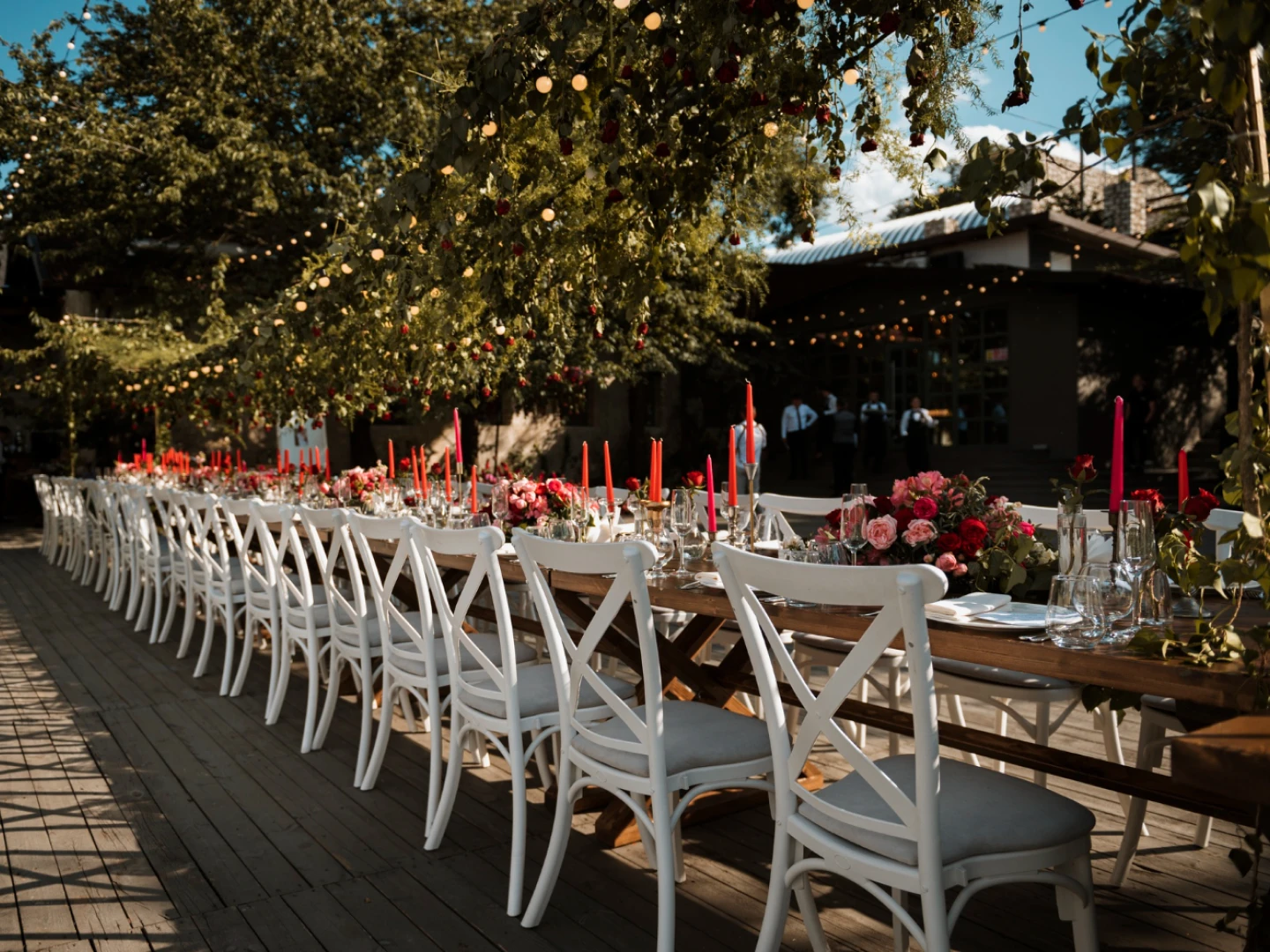 Outdoor villa wedding reception in the Limassol foothills, with long banquet table and candlelight under olive trees.