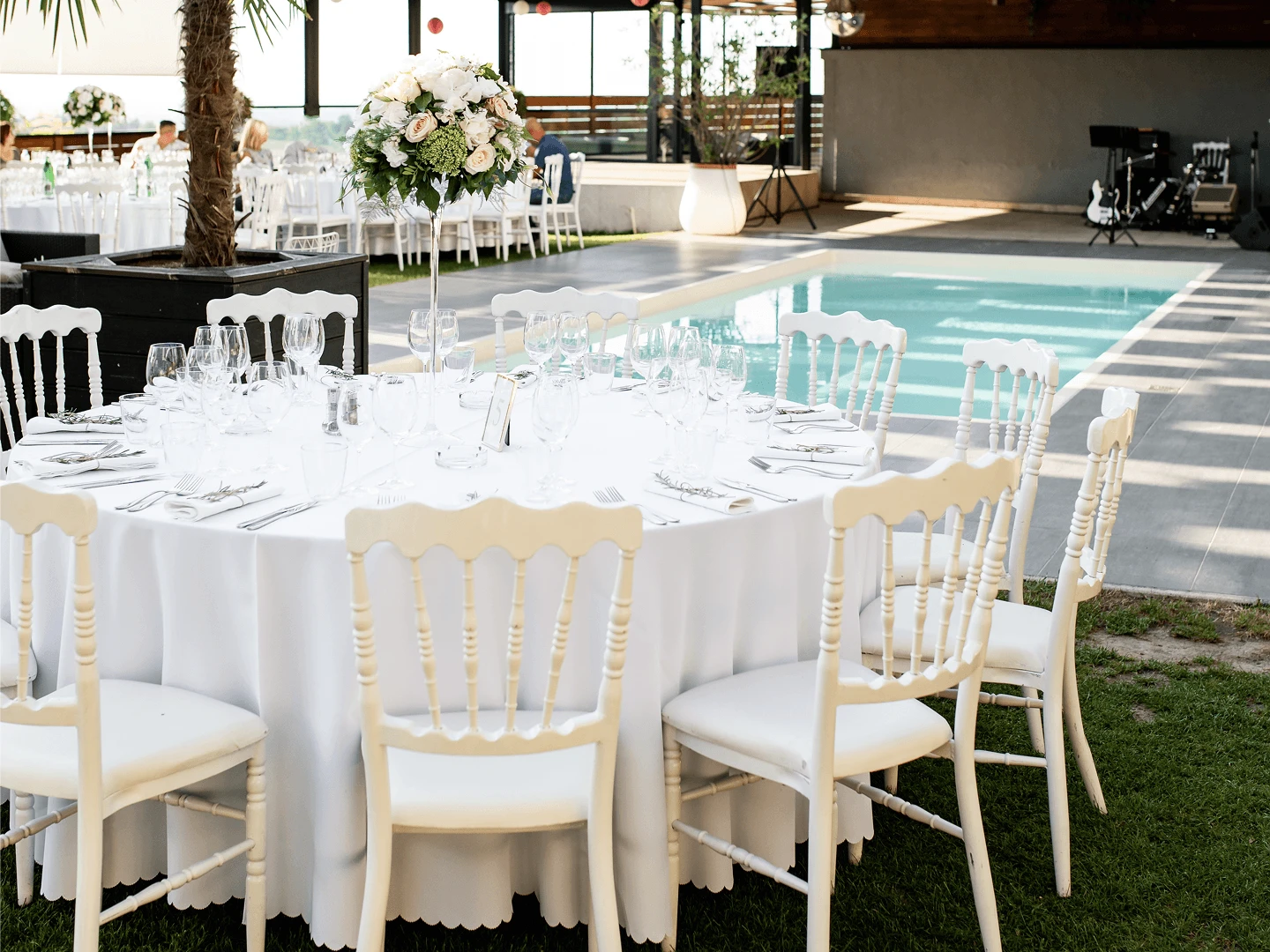 Private villa welcome dinner on a pool terrace in the Paphos hills, with long candlelit table and intimate guest seating.