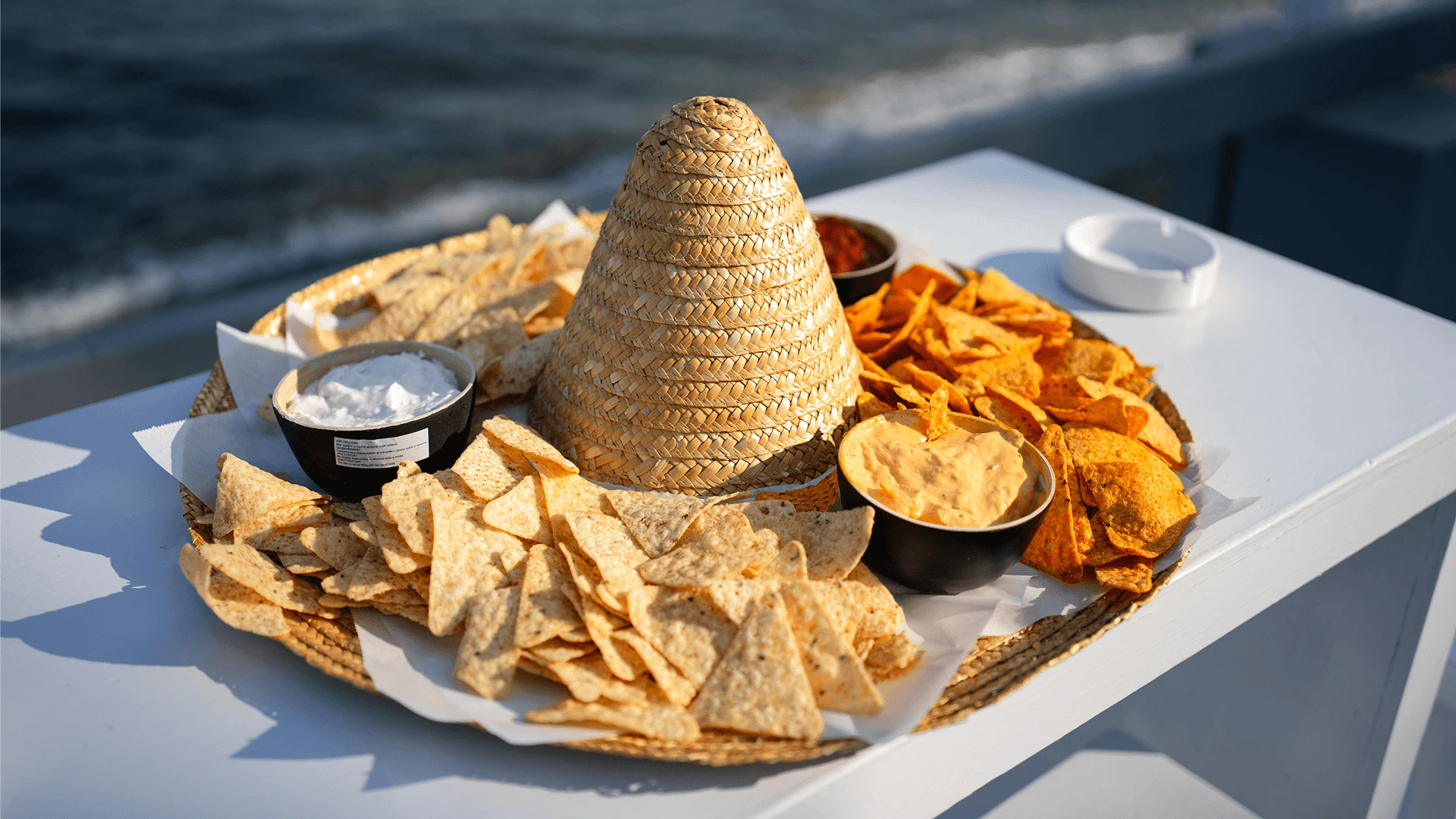 Platter of nachos with dips and a mini sombrero served seaside at a corporate event in Cyprus