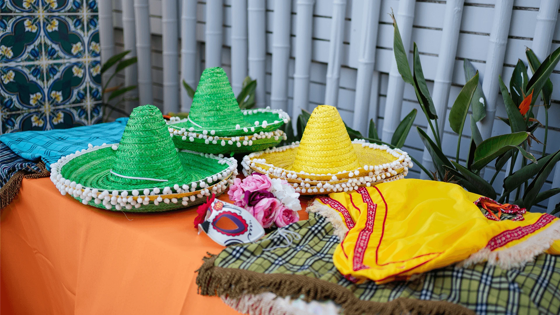 Colourful sombreros and themed party props laid out on a table for a fiesta-themed corporate event in Cyprus