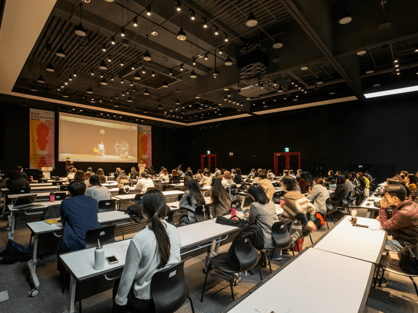 Five-star hotel conference hall in Limassol set with theatre seating, stage, and projection screen for a corporate forum.