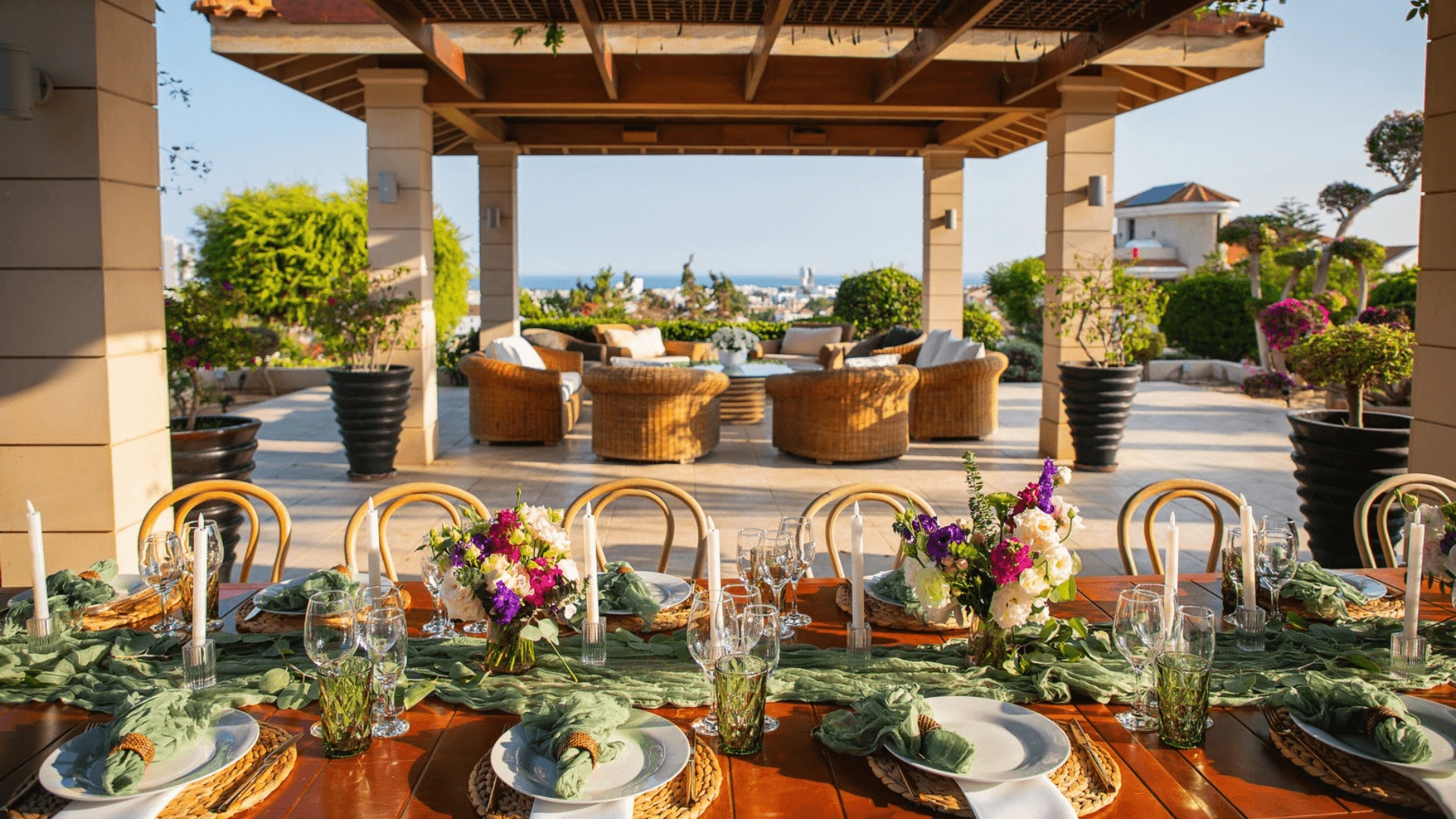 Banquet hall with an open terrace and sea view in Limassol, set for a corporate gala dinner.