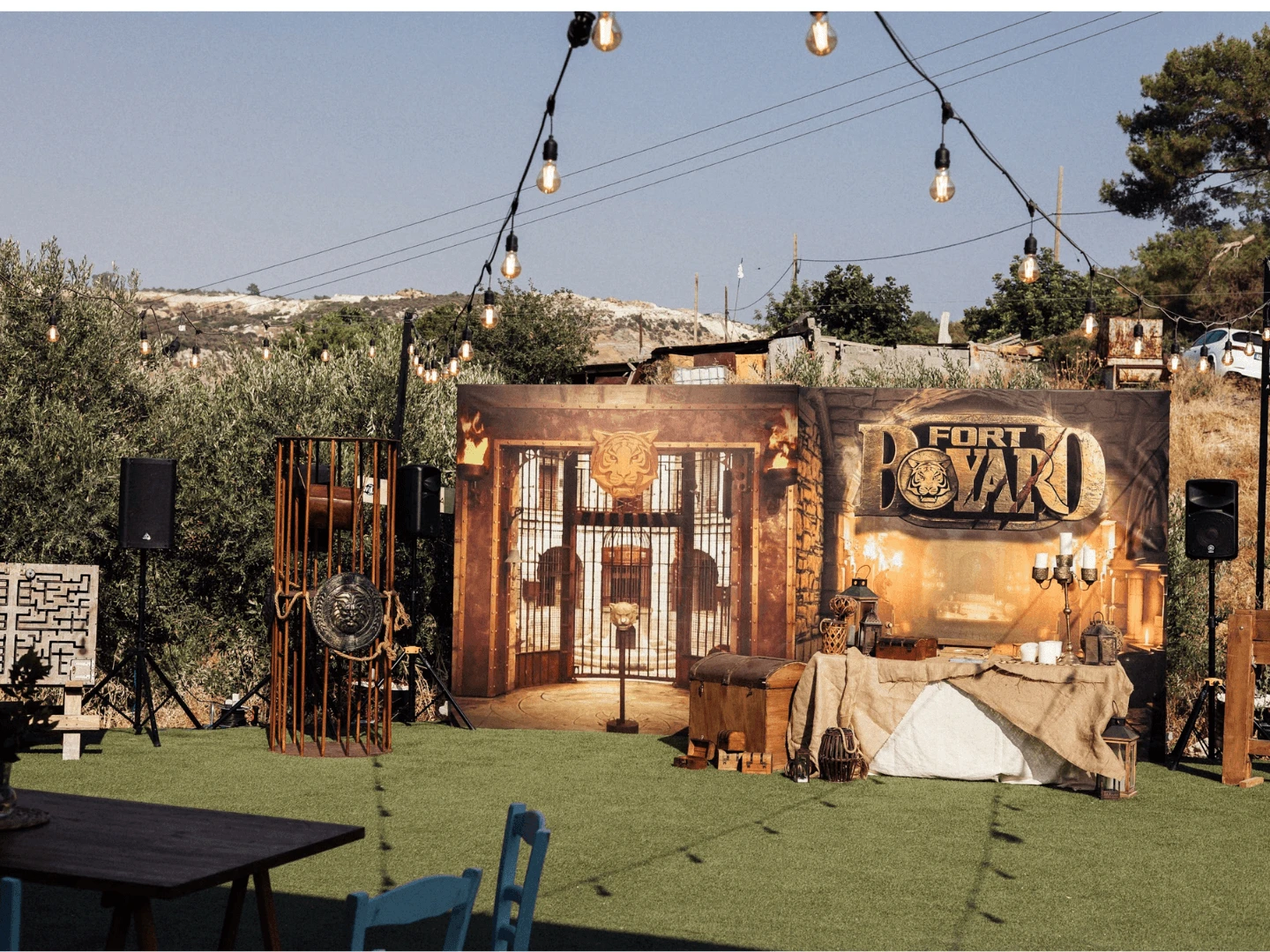 Fort Boyard themed outdoor game set with props and a tiger backdrop at a team building event in Cyprus
