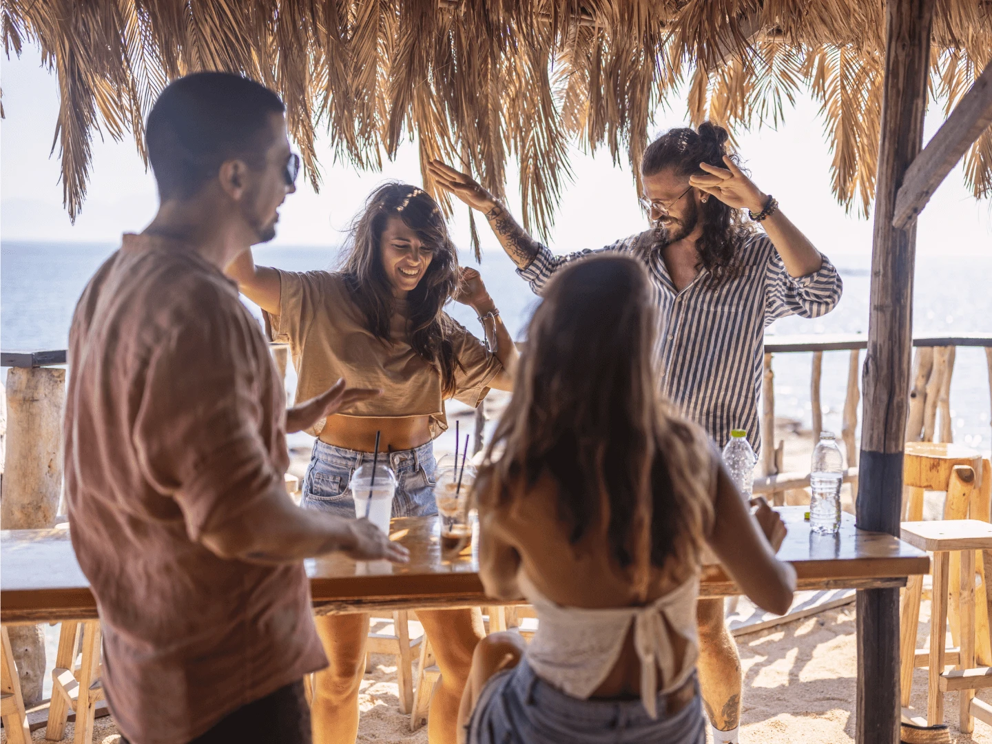 Day party at an Ayia Napa beach club — music, a bar on the sand, and a holiday party atmosphere.
