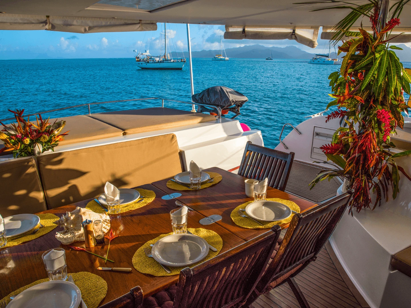 Dining table set for a meal on the deck of a catamaran with sea views during a yacht event in Cyprus