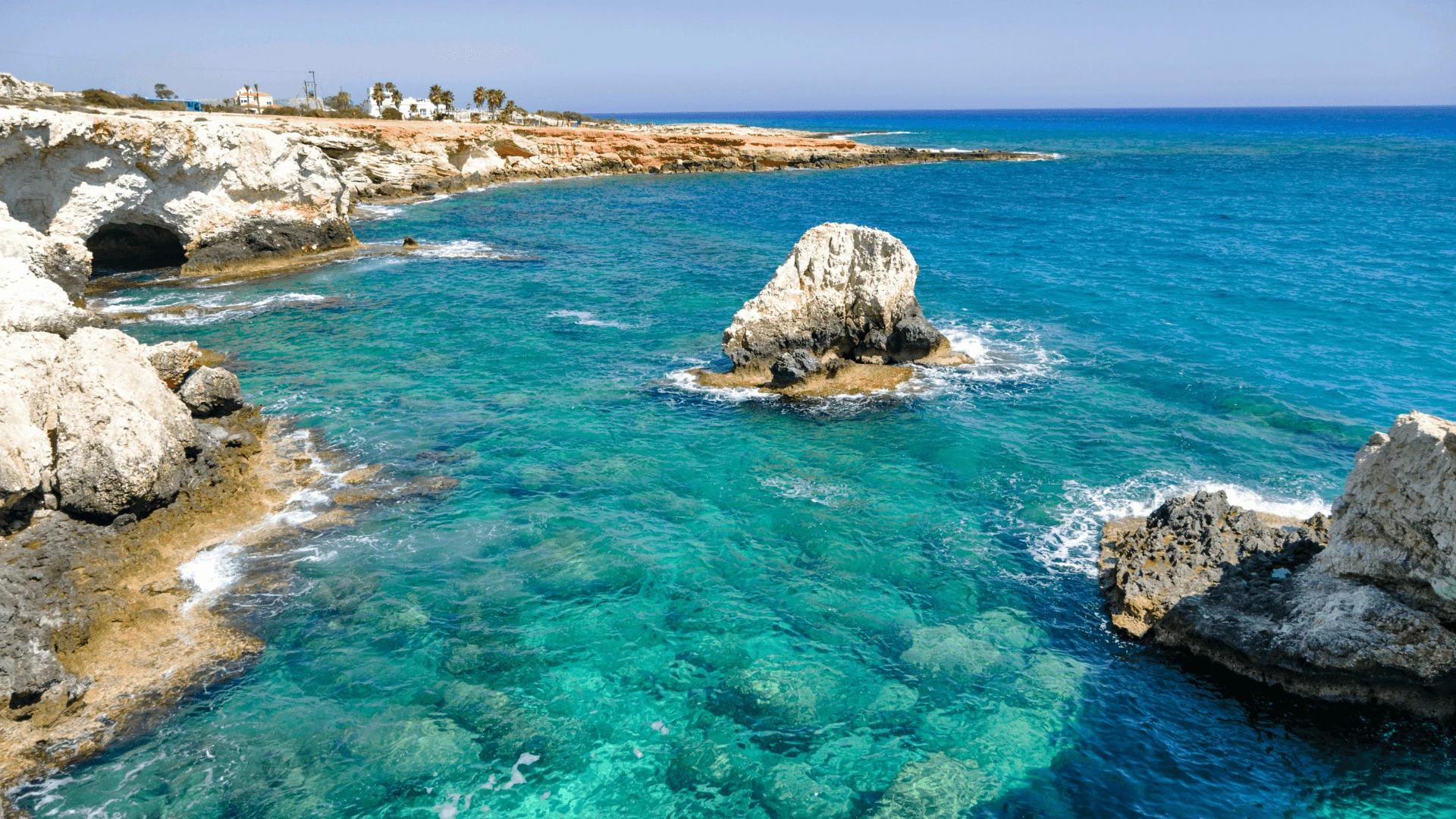 Clear turquoise water and rocky coastline at Cape Greco, a yacht anchorage near Ayia Napa in Cyprus