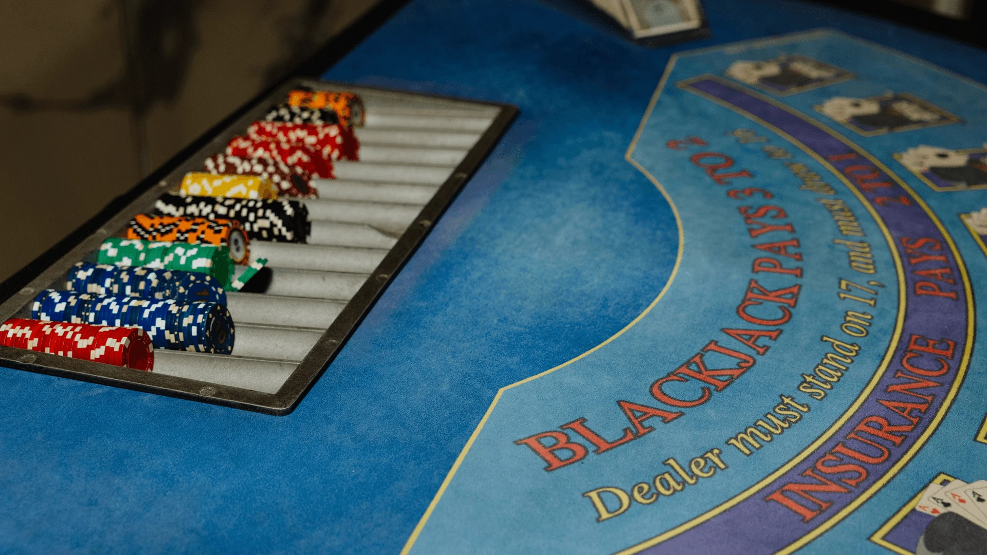 Blackjack table with a chip tray and playing surface markings at a casino-themed corporate event