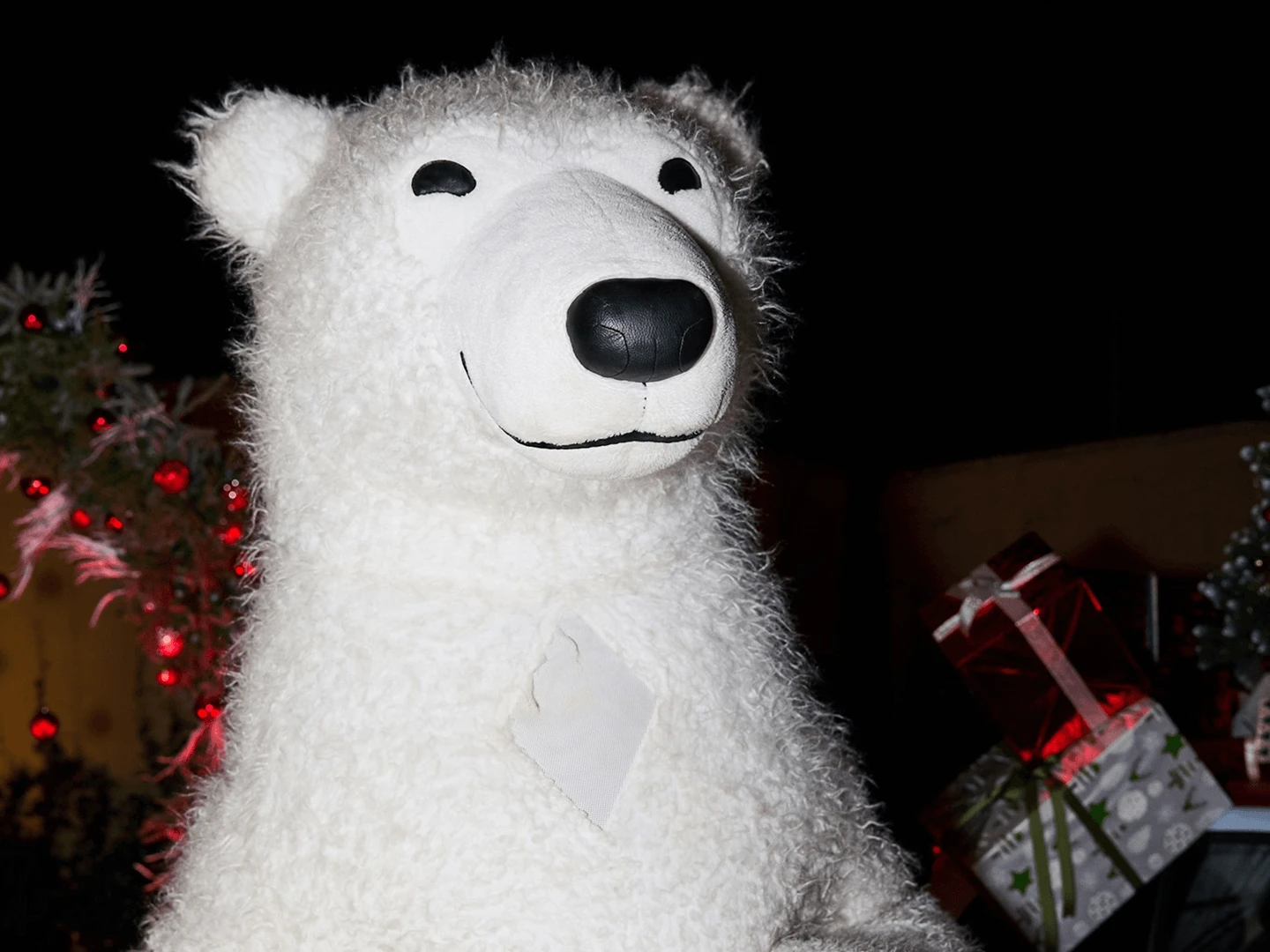 Large white bear character costume photographed close up at an evening corporate event
